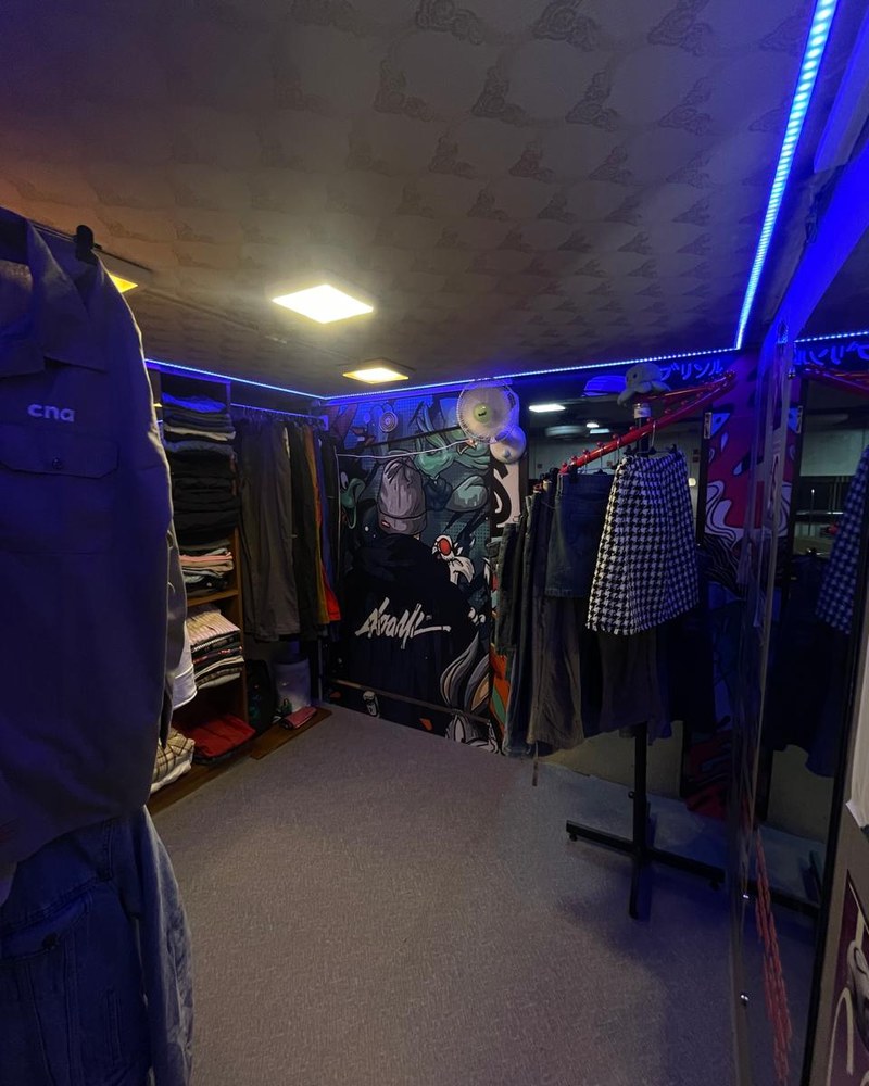 Inside Bombay Select — racks under blue LED light